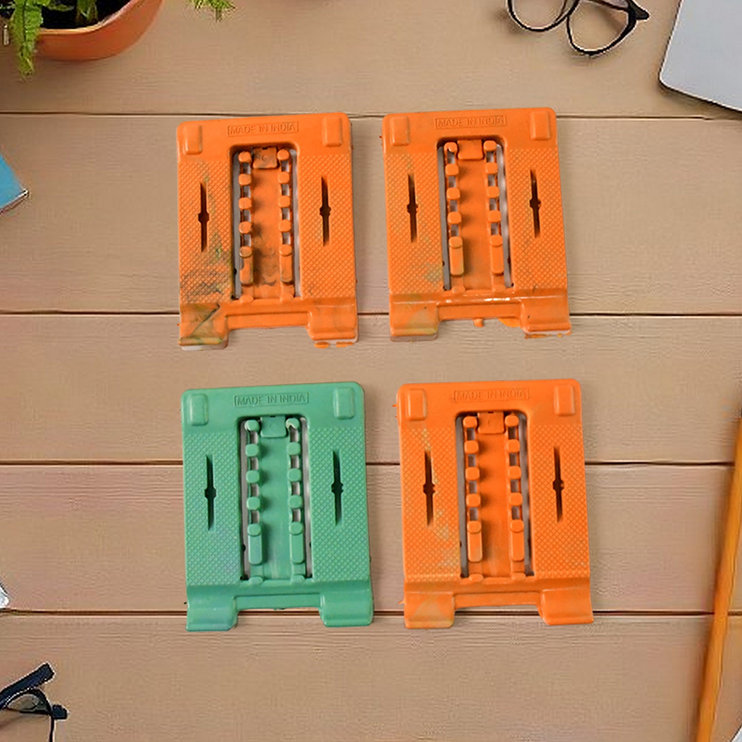 Set of four adjustable, foldable mobile stand holders by Wukusy, designed for flexible device support and easy portability.