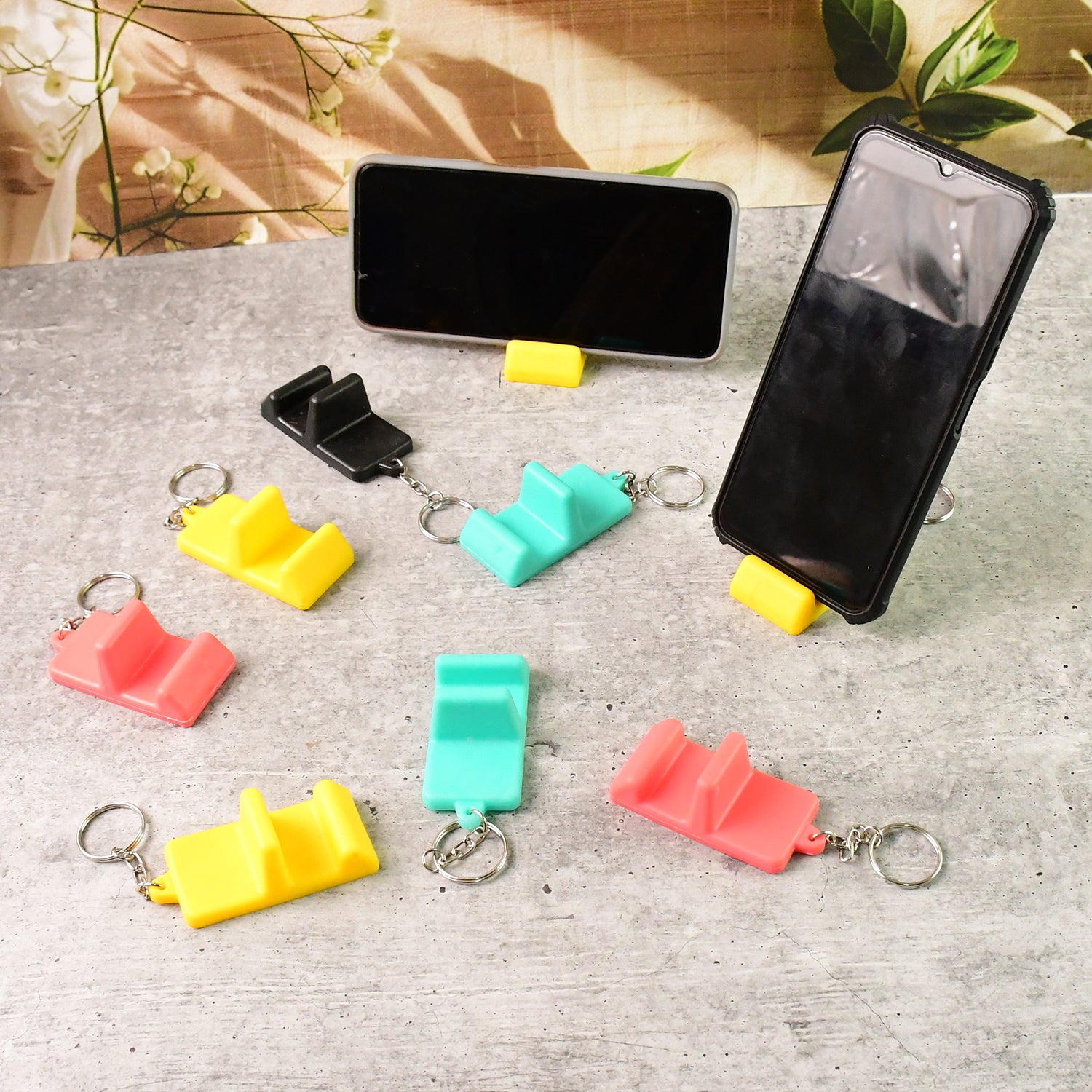 Set of nine Wukusy plastic 2-in-1 mobile stand keychains, compact mobile accessories for holding and displaying smartphones.