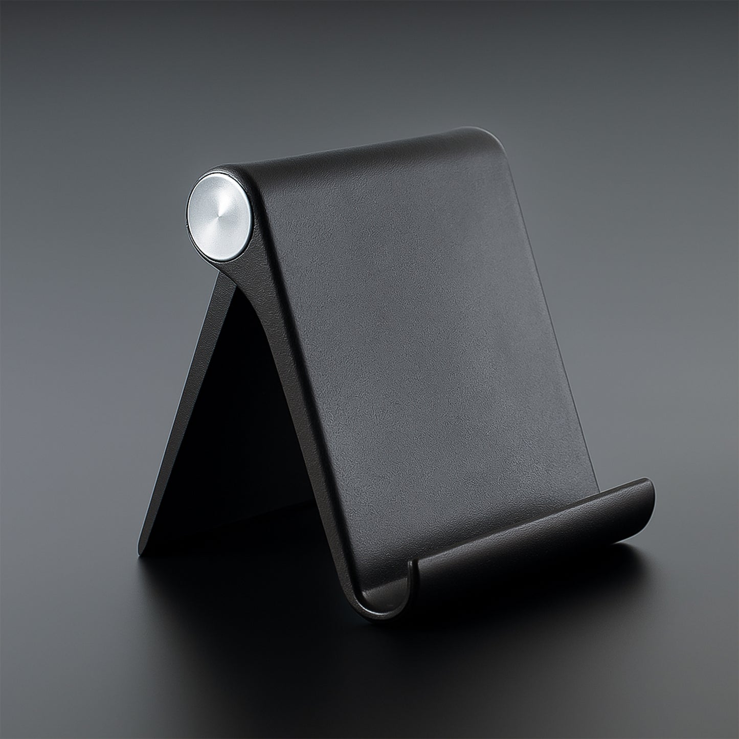 Black Wukusy plastic foldable desktop mobile stand, adjustable and lightweight for easy phone support on a desk.