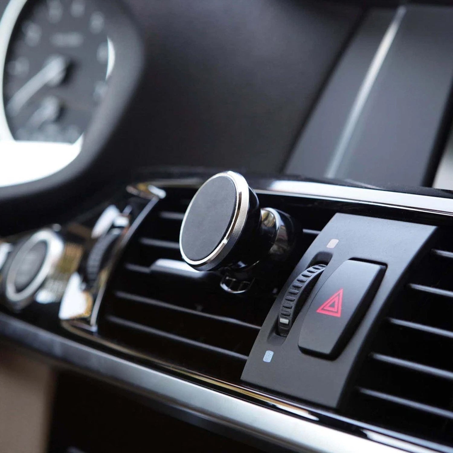 Wukusy universal magnetic car mobile holder attached to a vehicle dashboard, holding a smartphone securely.