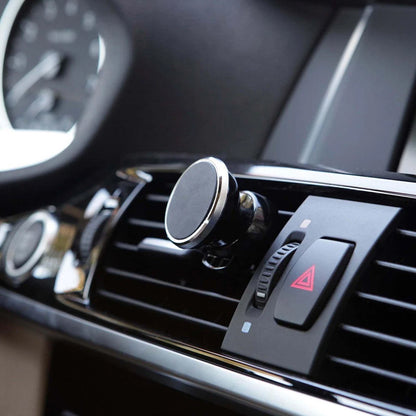 Wukusy universal magnetic car mobile holder attached to a vehicle dashboard, holding a smartphone securely.