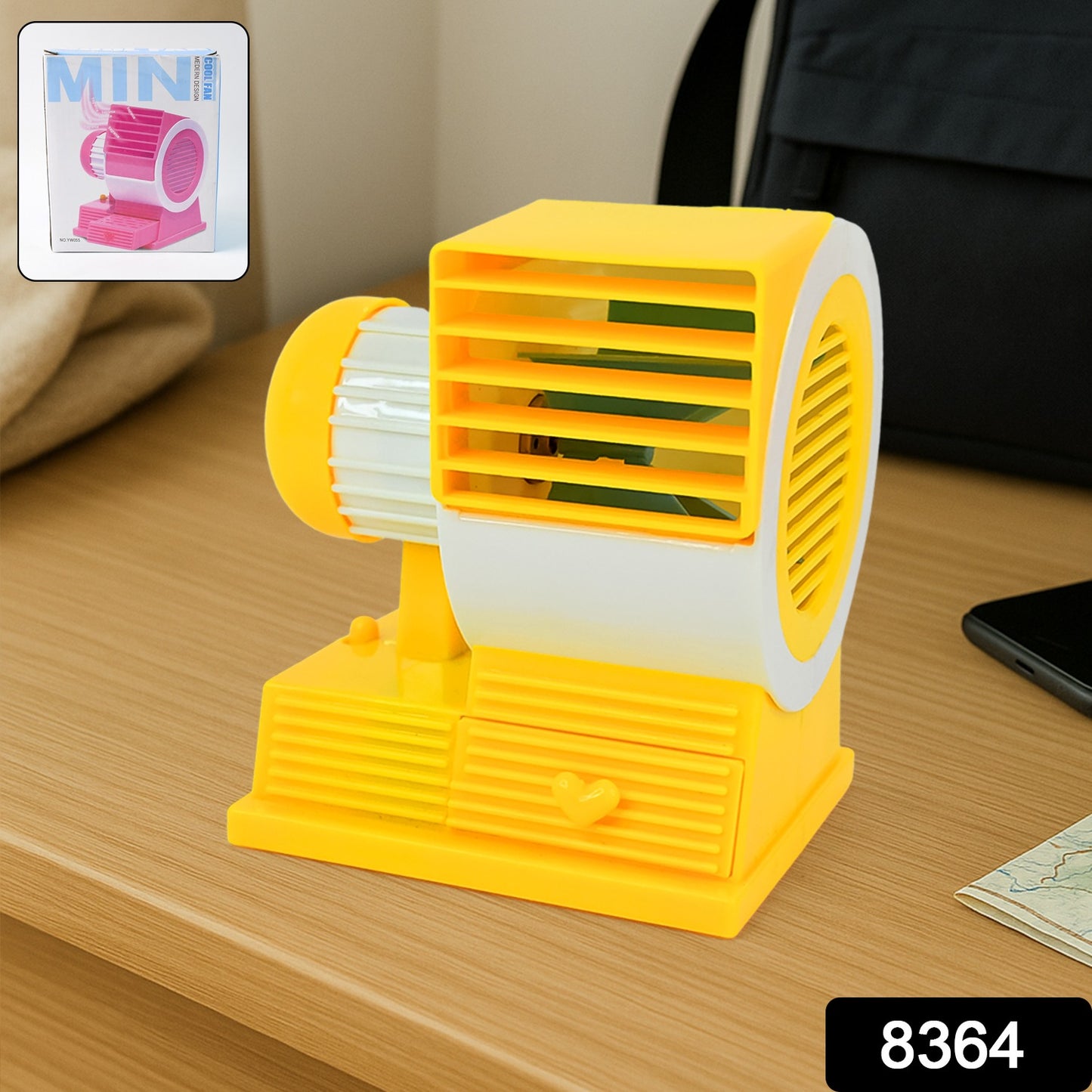 Wukusy Mini Dual-blade Portable USB Table Fan on office desk, compact personal cooling device with dual blades.