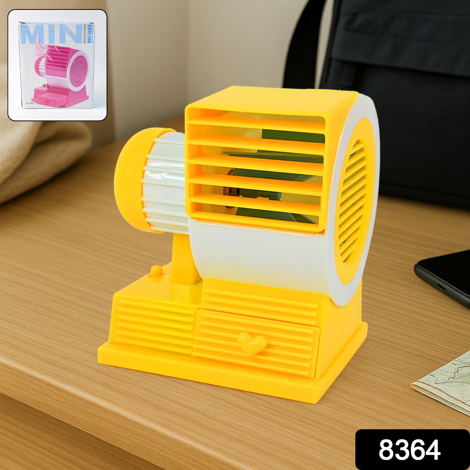 Wukusy Mini Dual-blade Portable USB Table Fan on office desk, compact personal cooling device with dual blades.