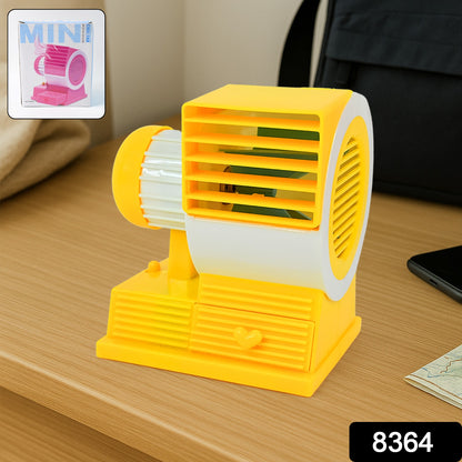 Wukusy Mini Dual-blade Portable USB Table Fan on office desk, compact personal cooling device with dual blades.