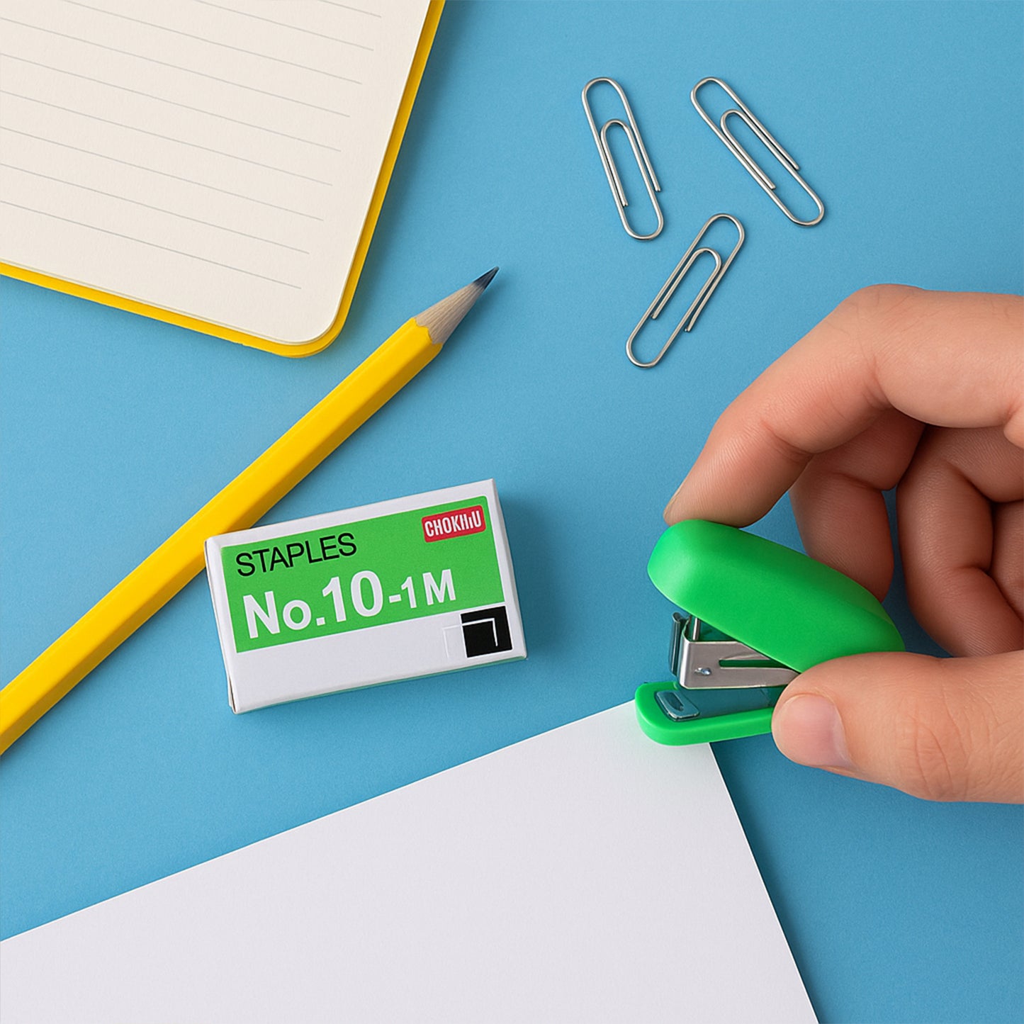 Wukusy mini office stapler with a strip of staples, compact and portable for quick paper fastening.