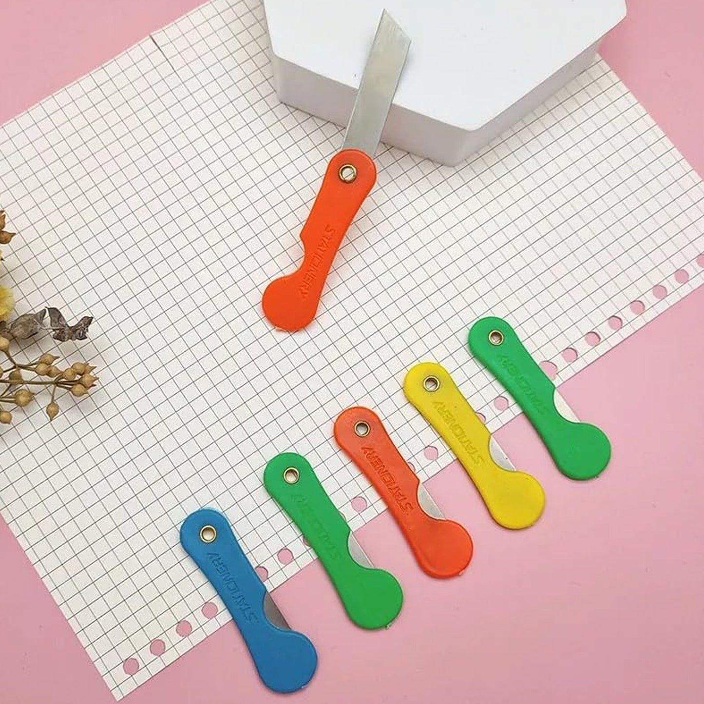 Pack of 12 multicolour Wukusy mini paper cutter knives, compact office pencil knives with sharp blades for precise cutting.