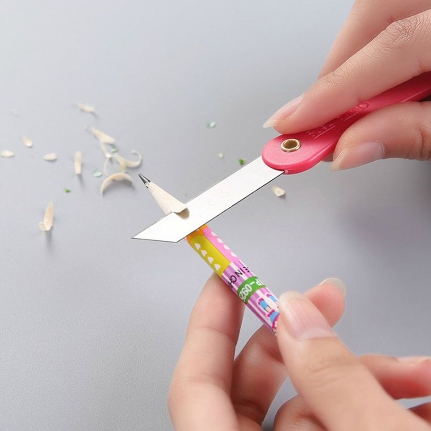 Set of 12 Wukusy multicolour mini paper cutter knives with pencil-style design for precise office cutting tasks.