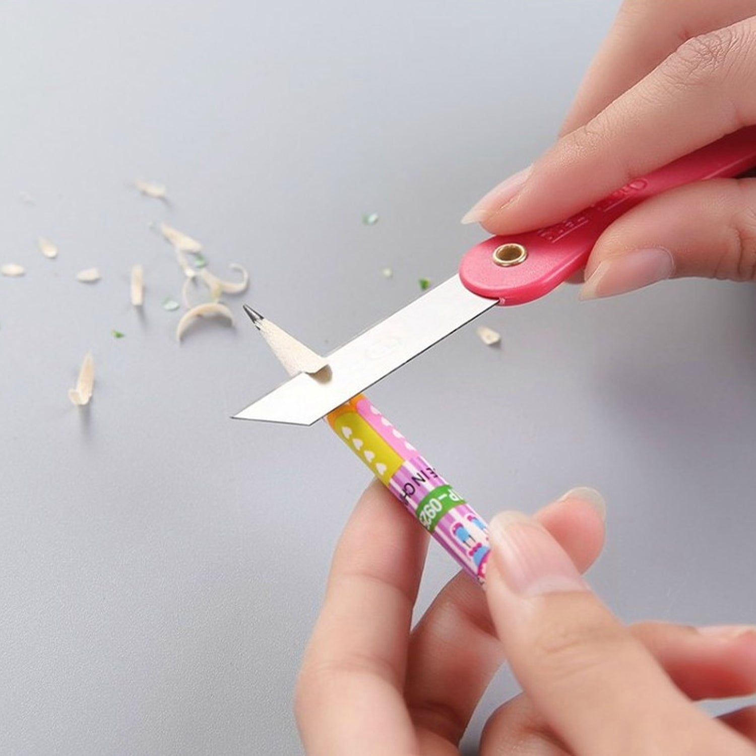 Set of 12 Wukusy multicolour mini paper cutter knives with pencil-style design for precise office cutting tasks.