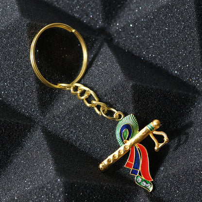 Wukusy Krishna flute keychain with intricate peacock feather design, showcasing detailed craftsmanship and vibrant colors.