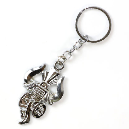 Silver keychain featuring Trishul, Damru, and Shiv symbol by Wukusy, showcasing intricate religious motifs on a keyring.