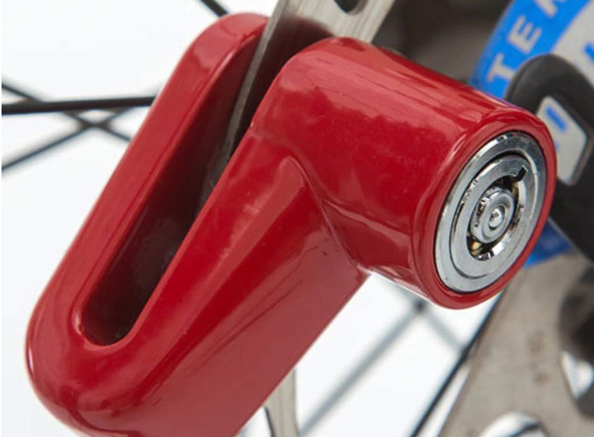 Wukusy 1514 Wheel Padlock Disc Lock for motorcycle, scooter, and bike security, showing the lock attached to a wheel.