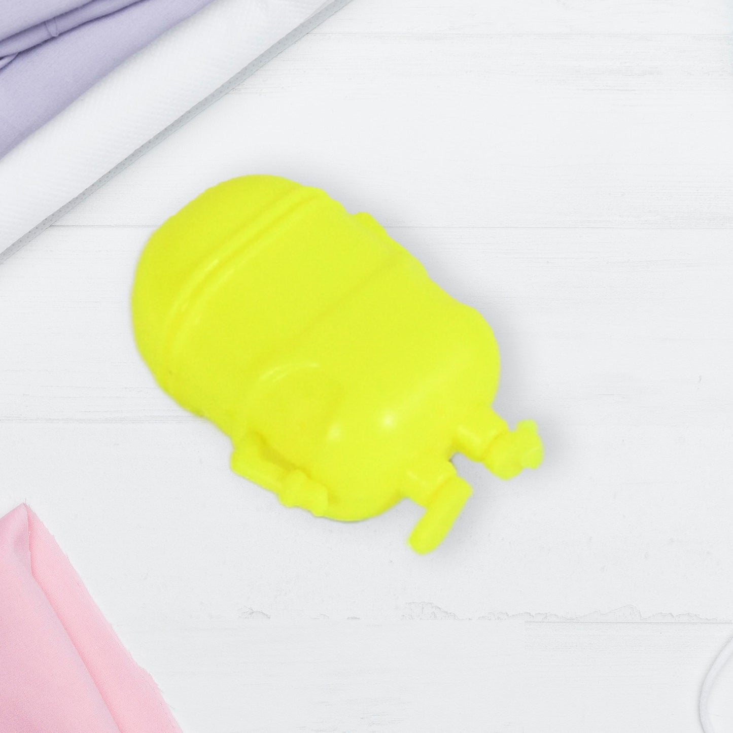 Small green Minion toy by Wukusy, featuring a cute, small-sized Minion design for kids, with detailed facial features and bright colors.