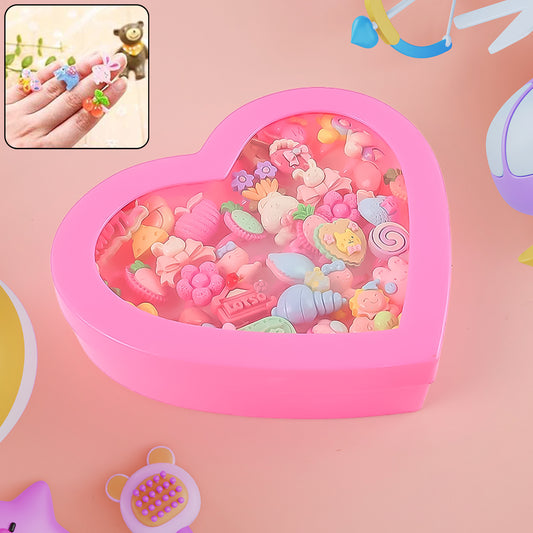 Set of 35 playful decorative rings for children by Wukusy in a heart-shaped storage box, featuring colorful, toy-style designs.