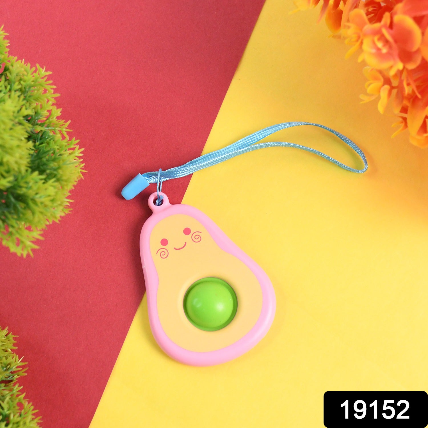 Cute avocado-shaped mini push pop keychain toy with strap, colorful and fun Wukusy brand accessory for kids and collectors.