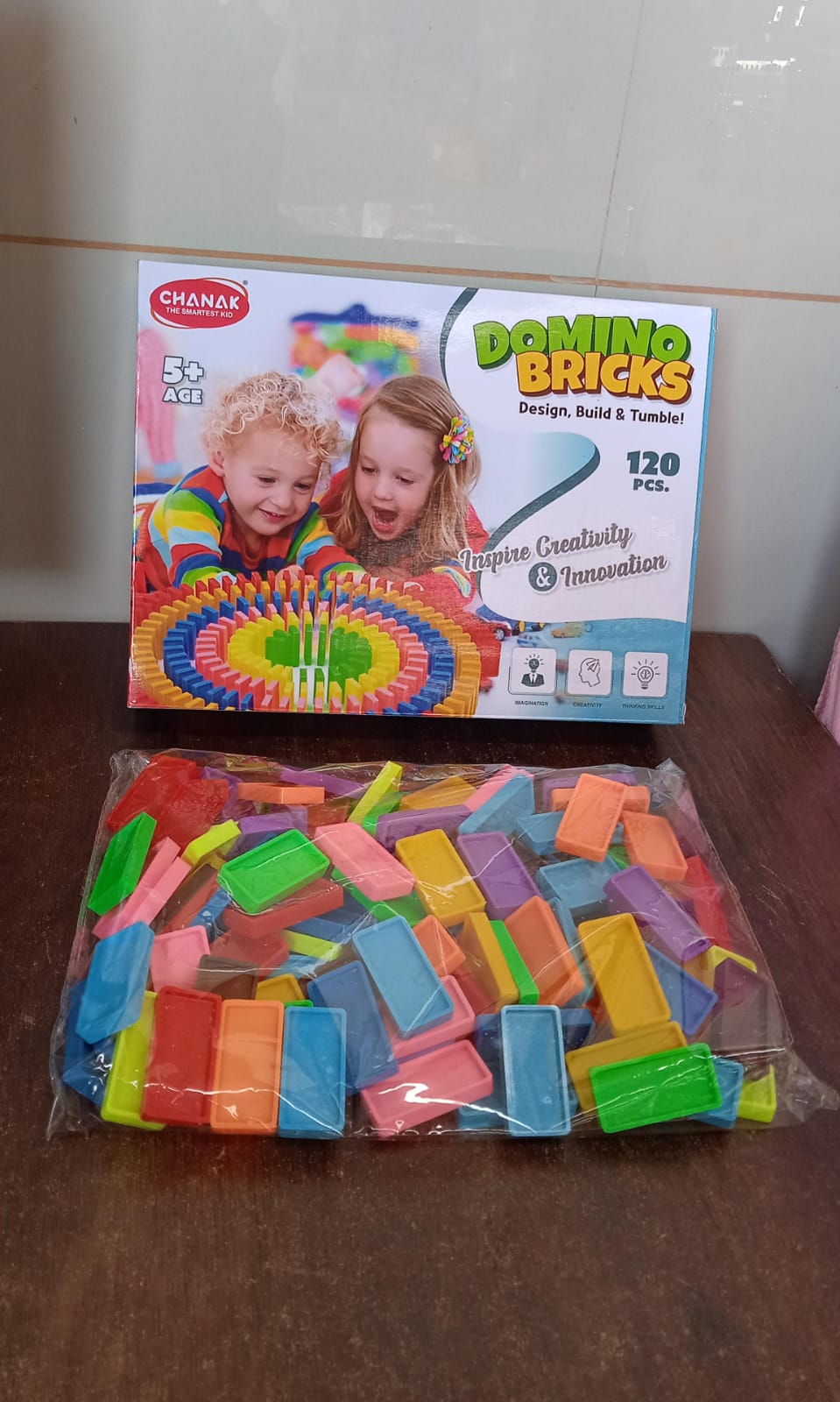 Wukusy Kids 120 Domino Blocks set featuring colorful plastic dominoes arranged in a playful pattern for children’s toy play.