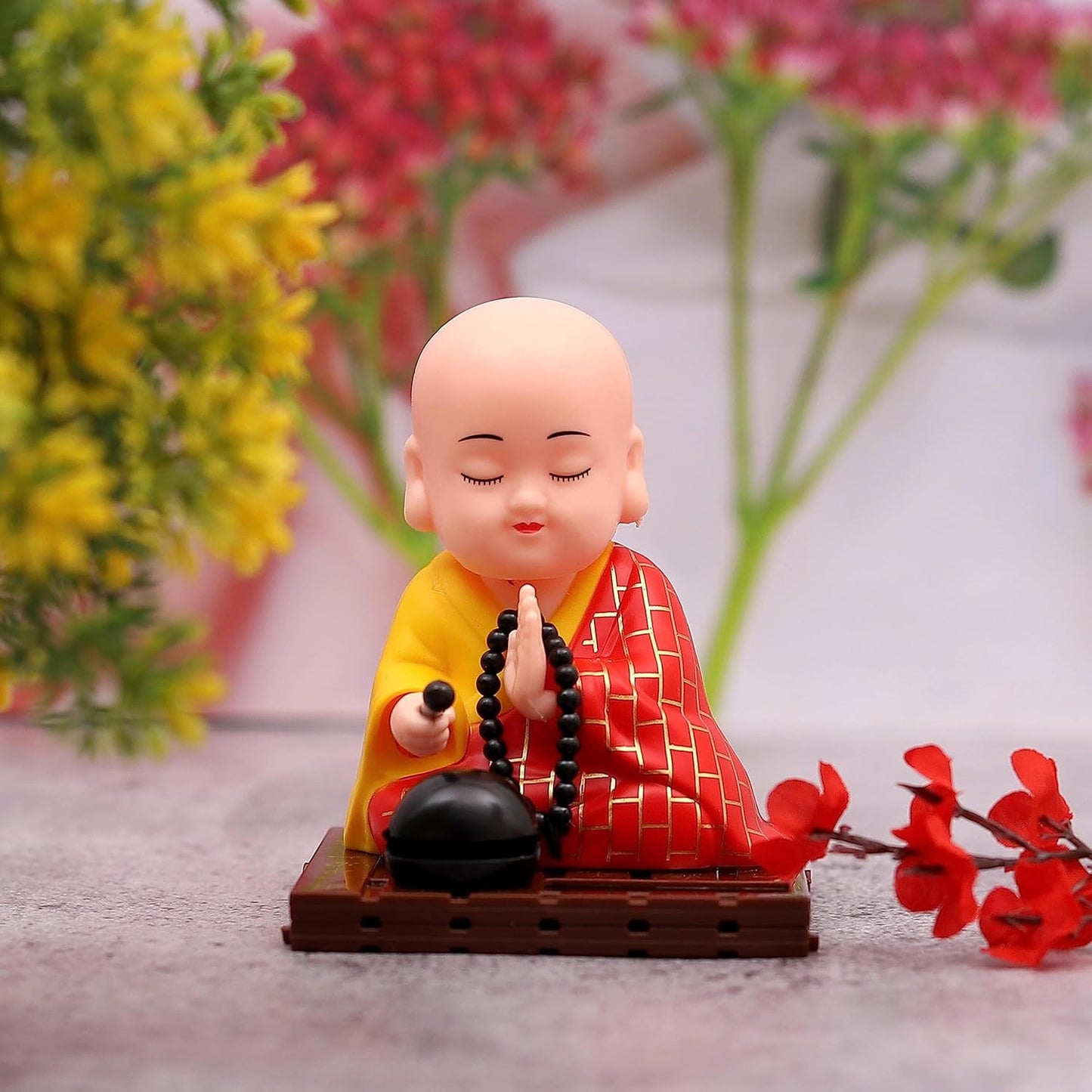 Large solar-powered sitting Buddha statue toy by Wukusy with moving head and hand, detailed and decorative for outdoor display