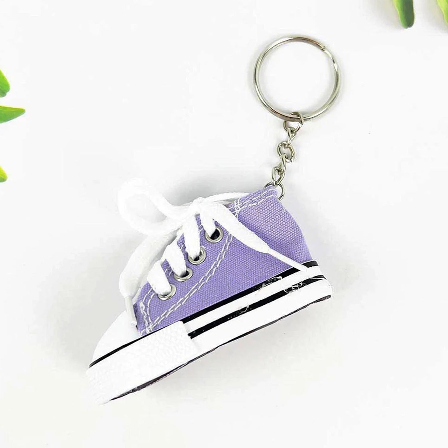 Wukusy Mini Shoes Travel Keychain attached to a backpack, stylish accessory perfect for gifts and travel gear.