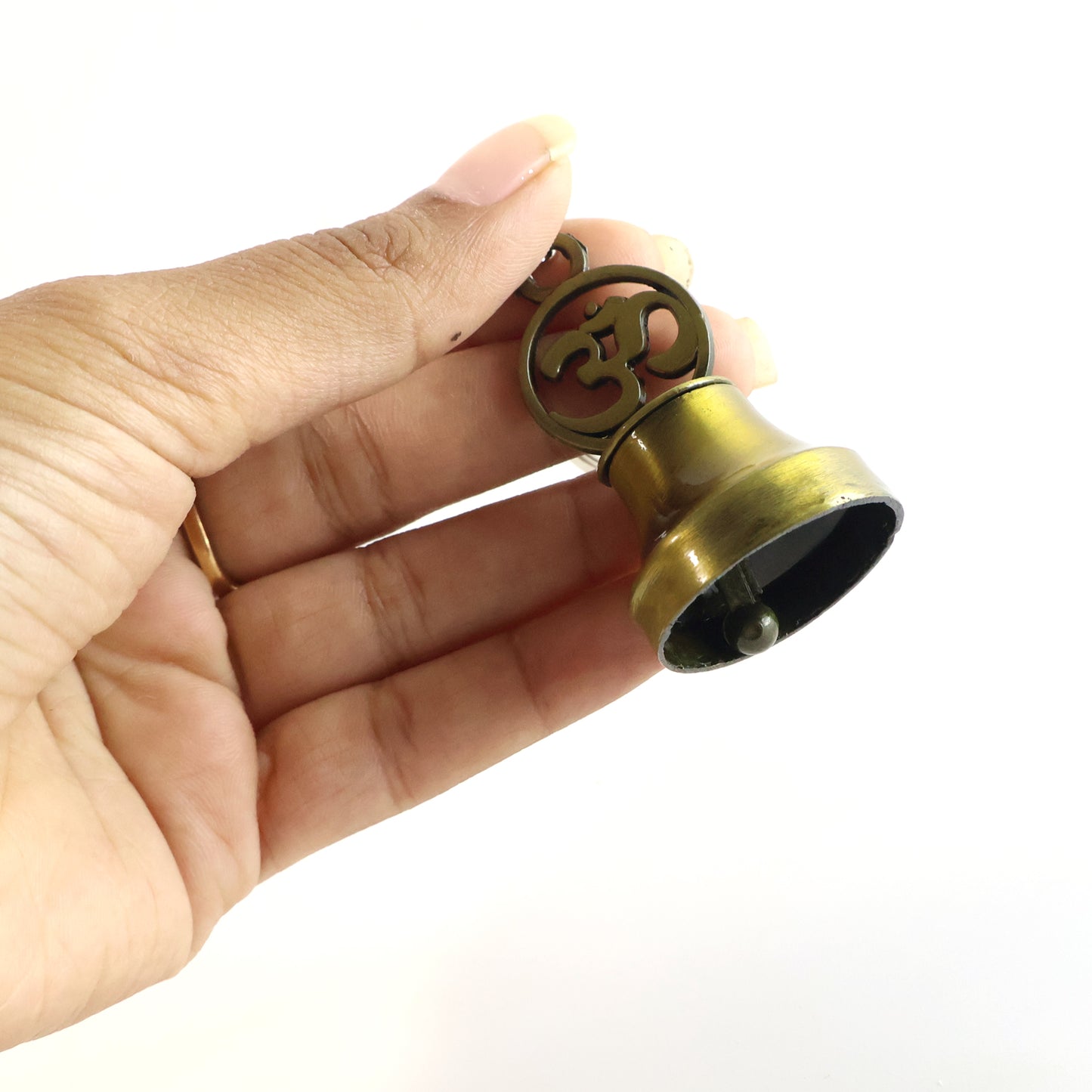 Wukusy Om Symbol Temple Bell metal keychain for travel, featuring a decorative Om symbol and bell, made of durable metal.