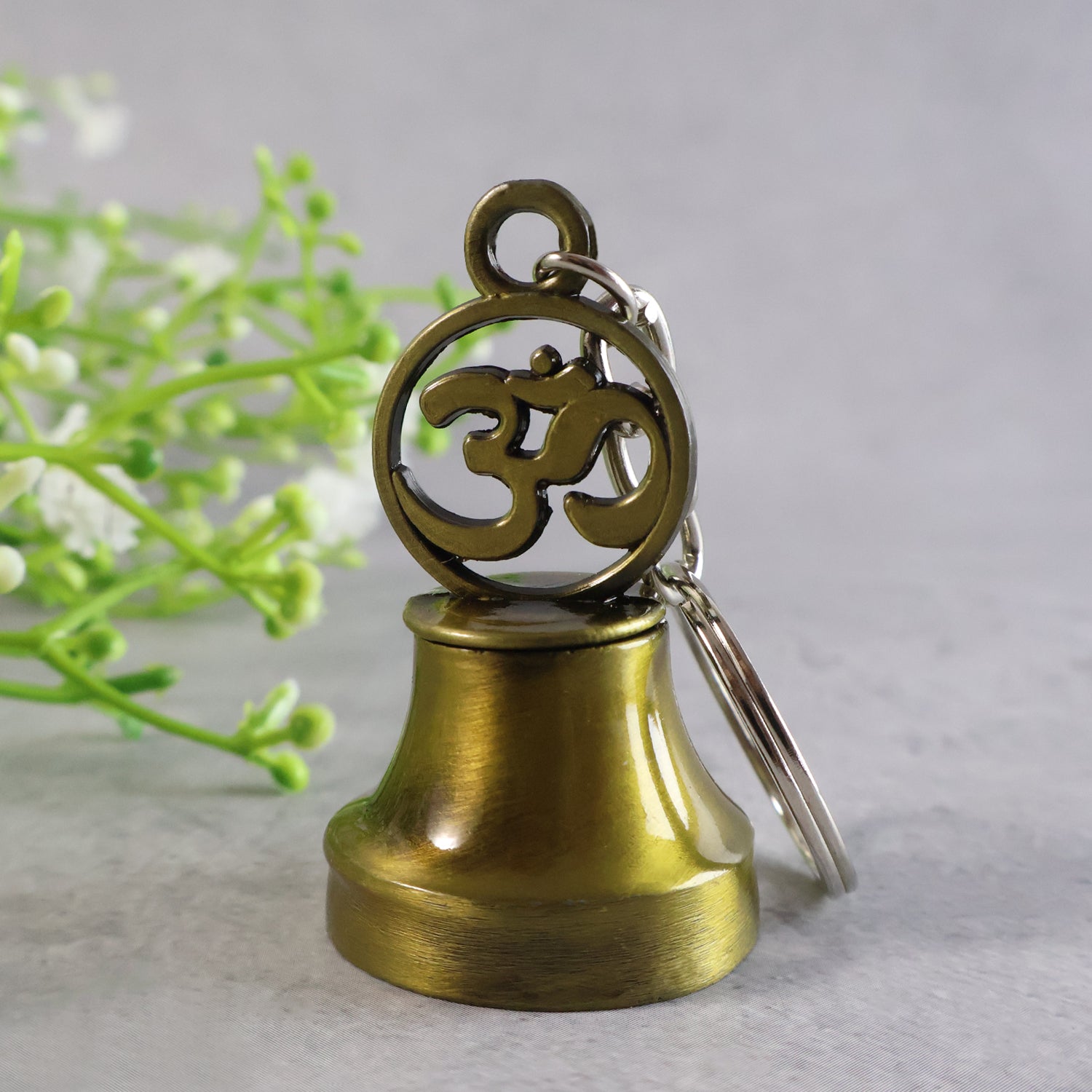 Wukusy Om Symbol temple bell metal keychain, travel accessory with intricate Om design and small bell, durable metal construction.