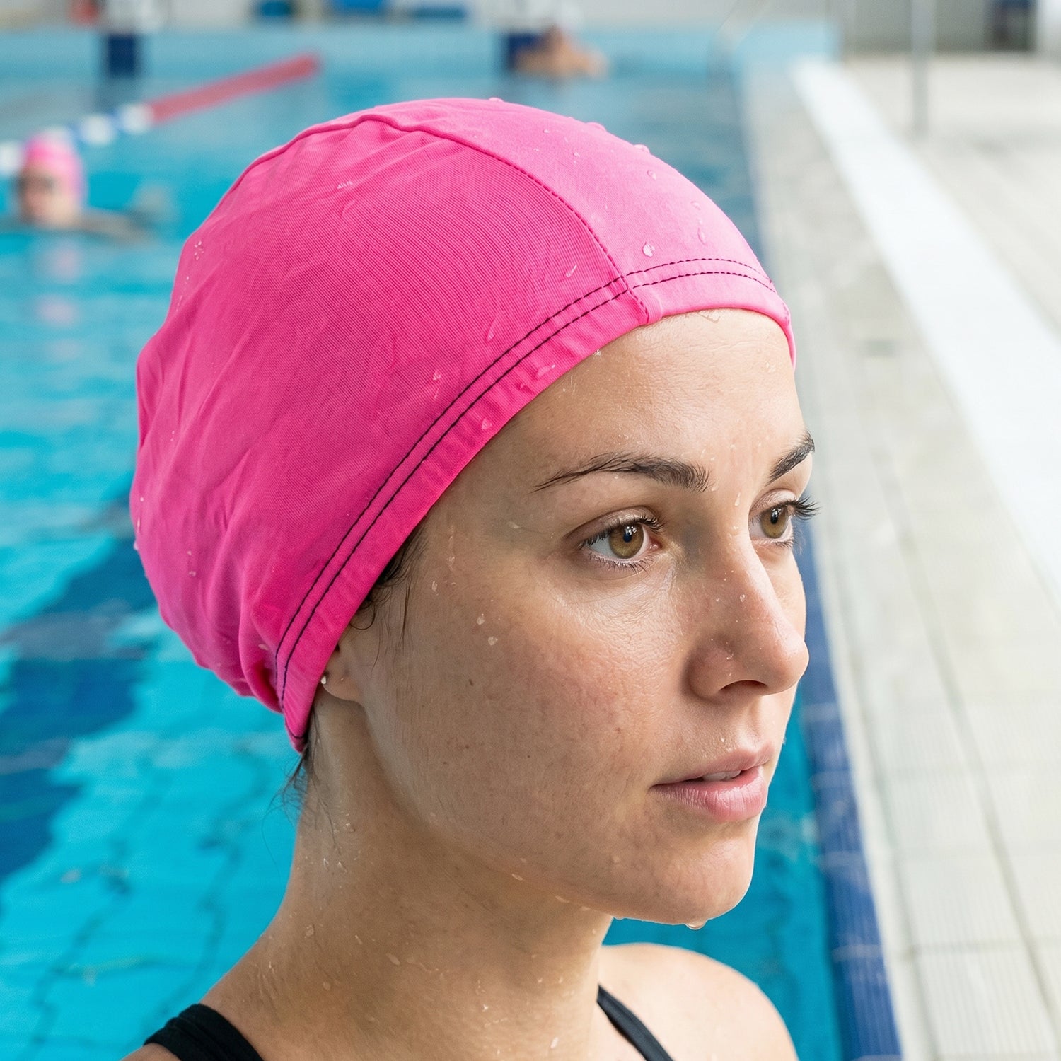 Small Wukusy premium stretchable swimming cap, showing a close-up of the smooth, elastic fabric designed for comfortable fit.