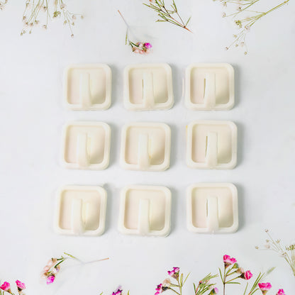 Set of 9 Wukusy adhesive hooks for wall hanging clothes, strong and easy to install for home organization and storage.