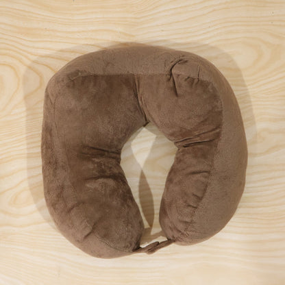 Brown plush U-shaped travel neck pillow by Wukusy, designed for comfortable head and neck support during travel.