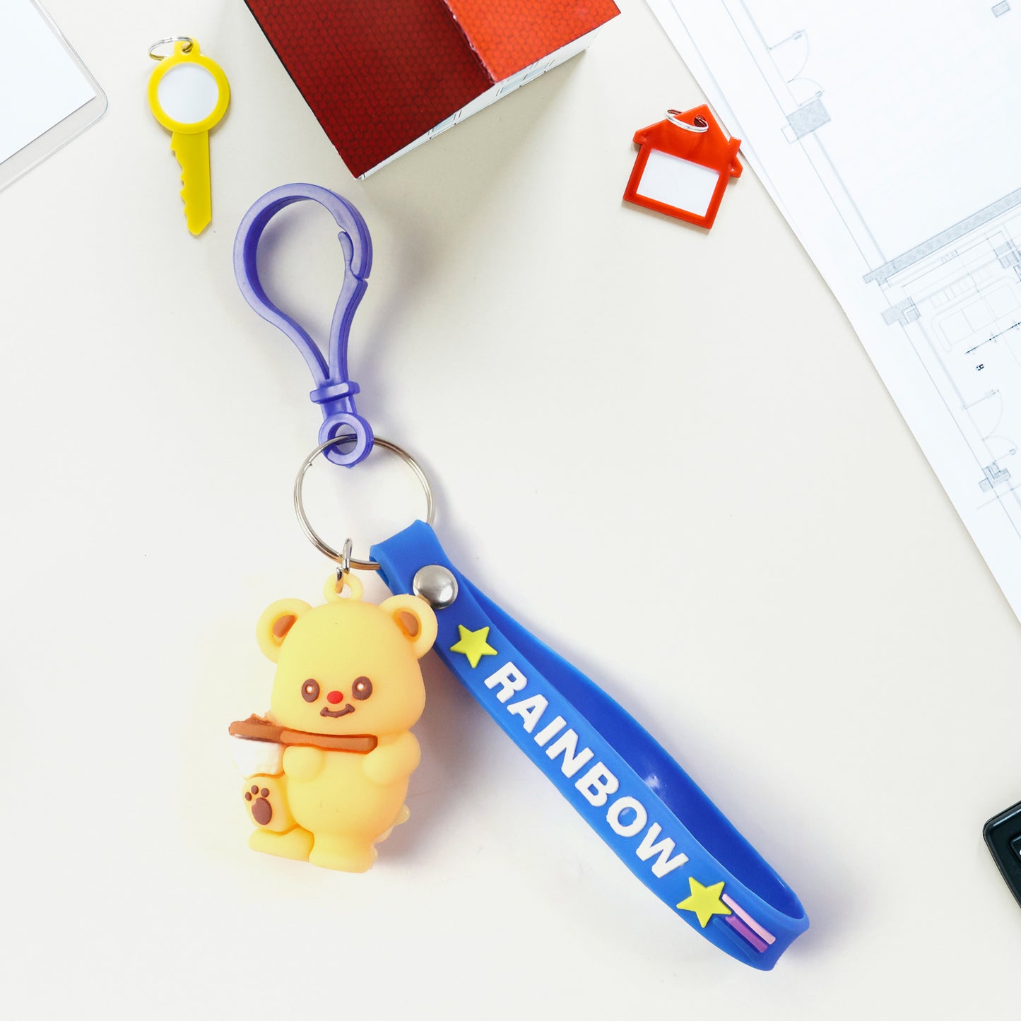 Cute bear character keychain by Wukusy featuring a detailed plush bear design with a loop for attaching to keys or bags.