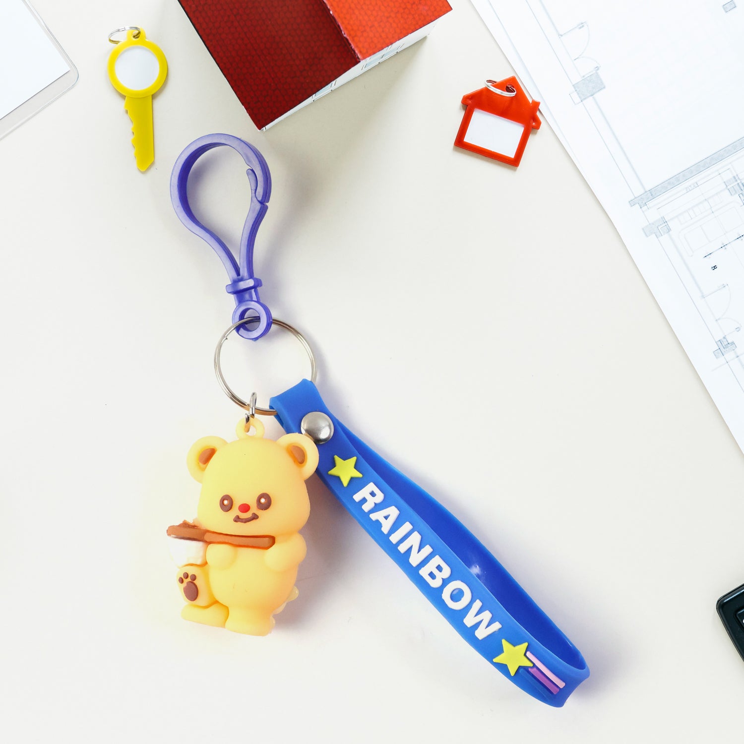 Cute bear character keychain by Wukusy featuring a detailed plush bear design with a loop for attaching to keys or bags.