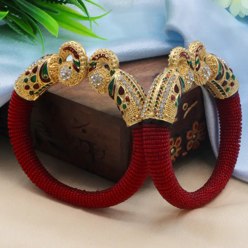 Traditional peacock design pearl bangles for women featuring intricate craftsmanship and elegant white pearl accents.