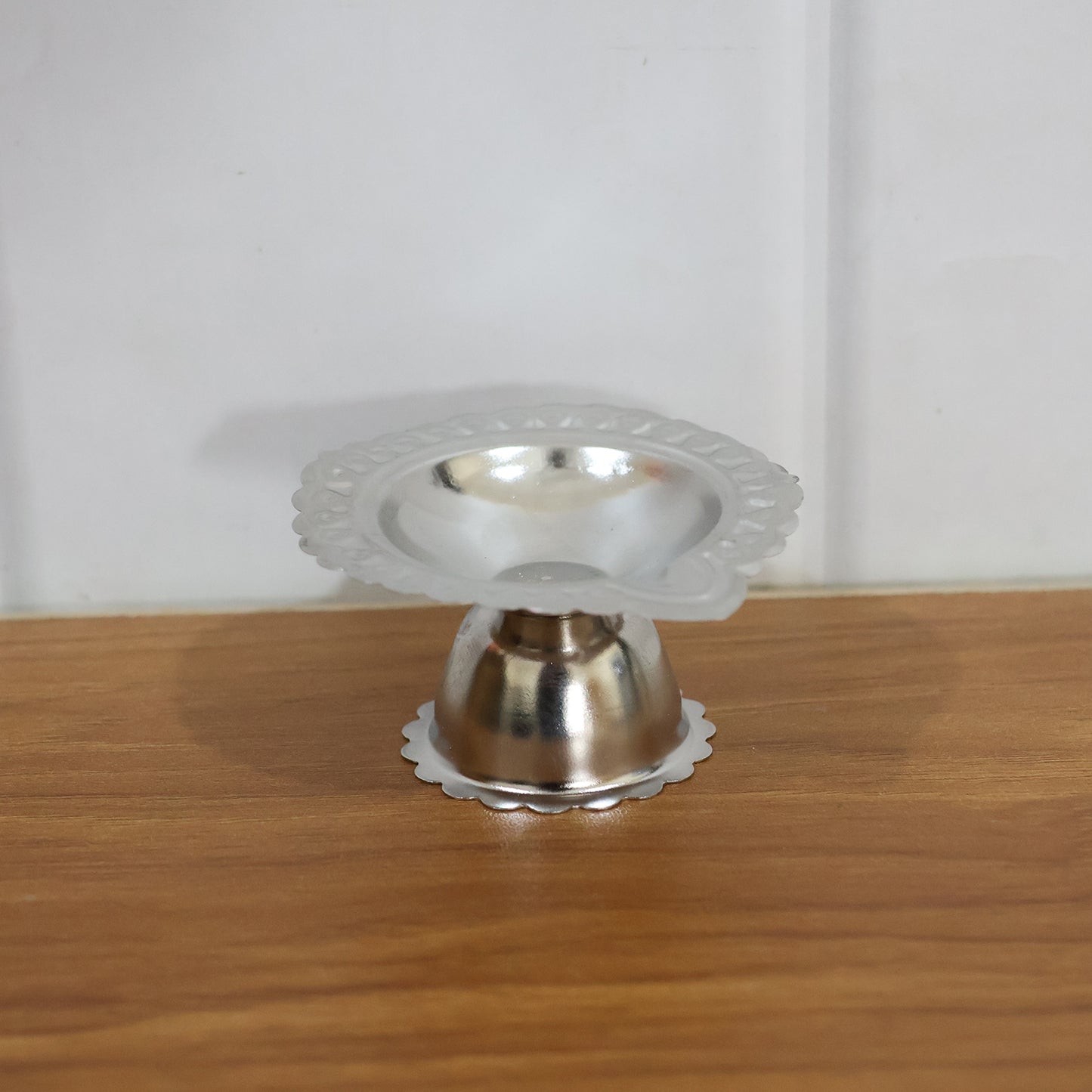 Stainless steel traditional Puja diya stand with multiple holders for diyas, designed for religious ceremonies and prayer rituals.