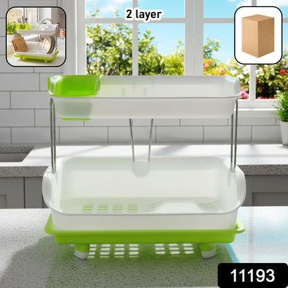 Wukusy Prexo 2-layer kitchen dish drying rack with drain tray, holding plates, cups, and utensils in a modern kitchen setting