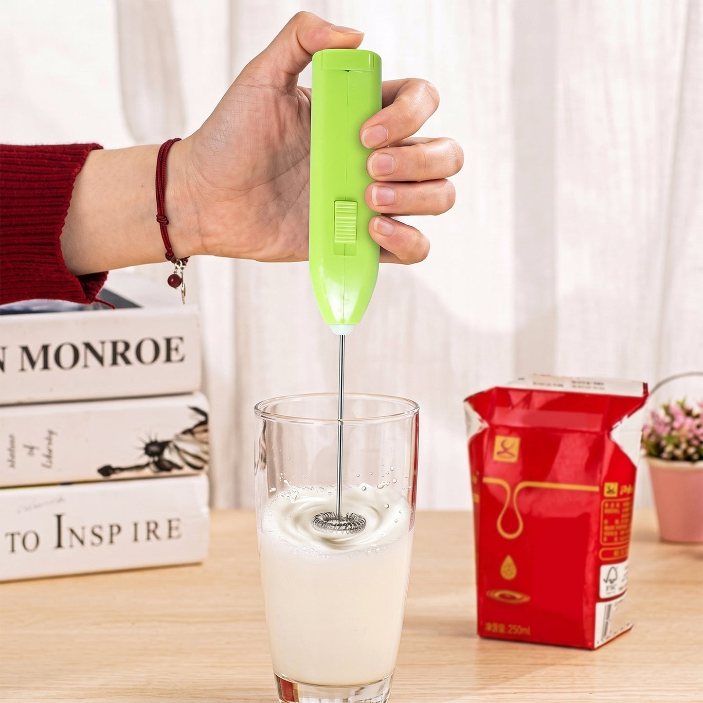 Wukusy handheld electric milk frother with mini whisk for coffee and eggs, compact handheld kitchen tool in black and silver.