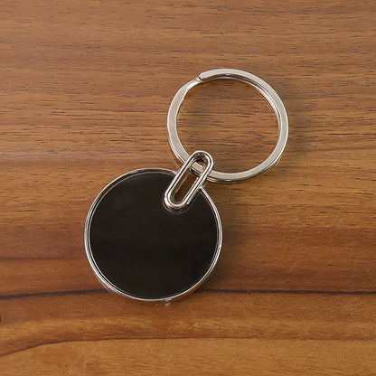 Black round metal keychain with sleek finish and Wukusy branding, designed for holding keys and accessories.