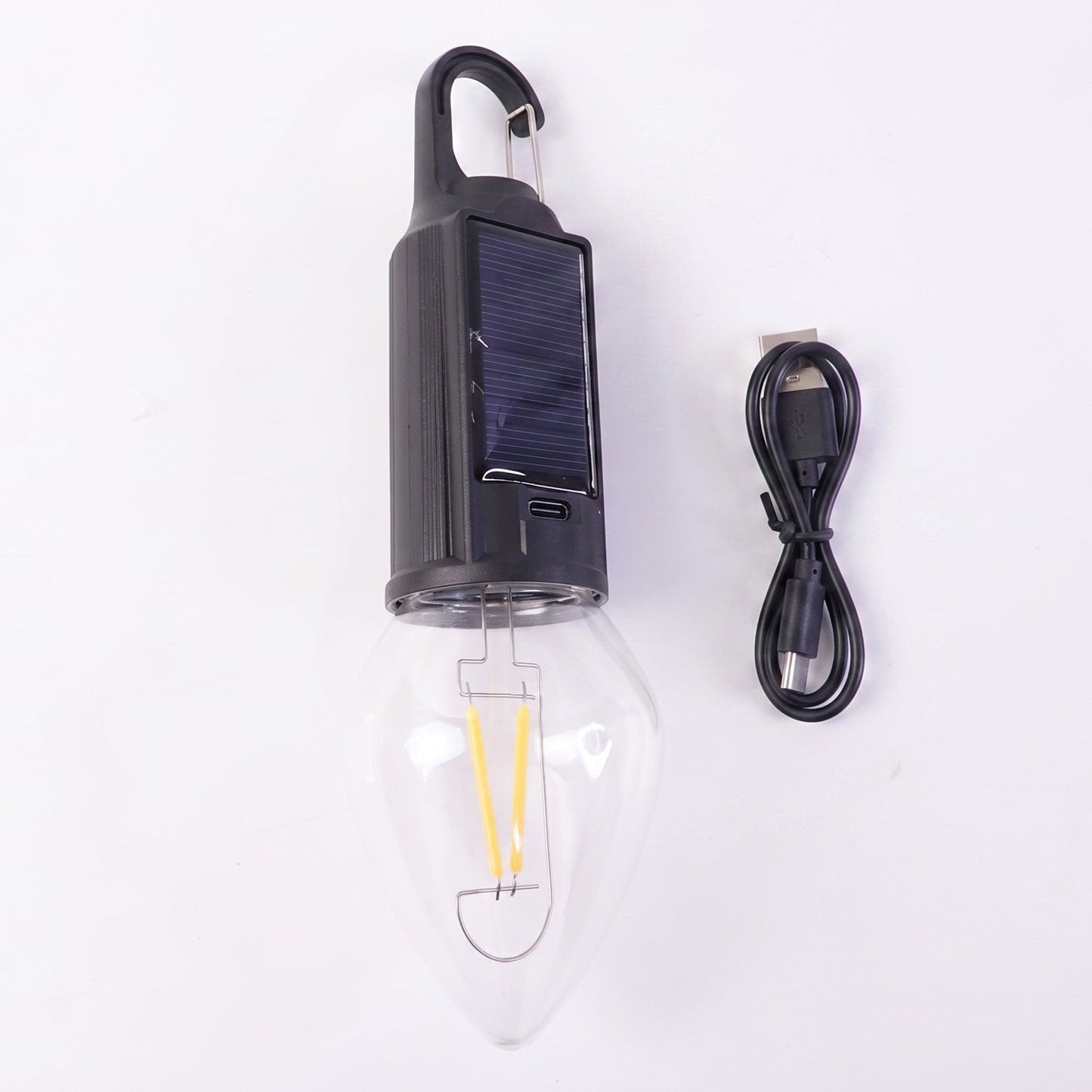 Wukusy solar rechargeable camping lamp with warm LED light and carabiner clip, ideal for outdoor camping and hiking adventures