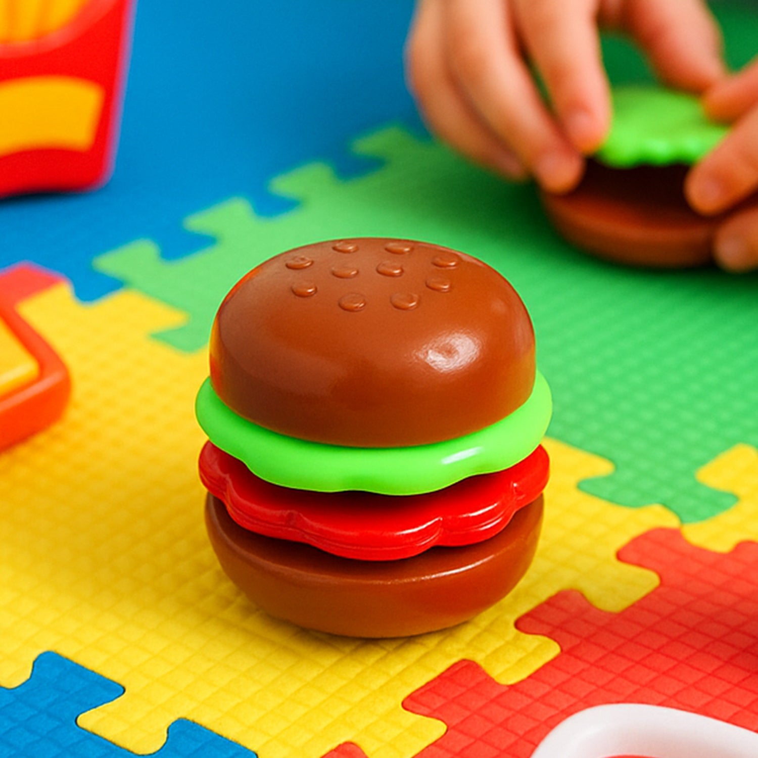 Mini burger-shaped toy for kids by Wukusy, featuring colorful, realistic burger details on a small, playful toy.