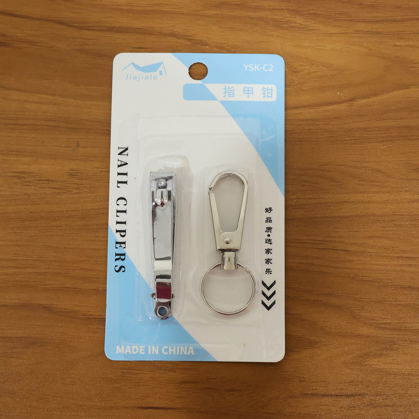 Wukusy stainless steel nail clipper set with two nail clippers and keychain holder on a white background