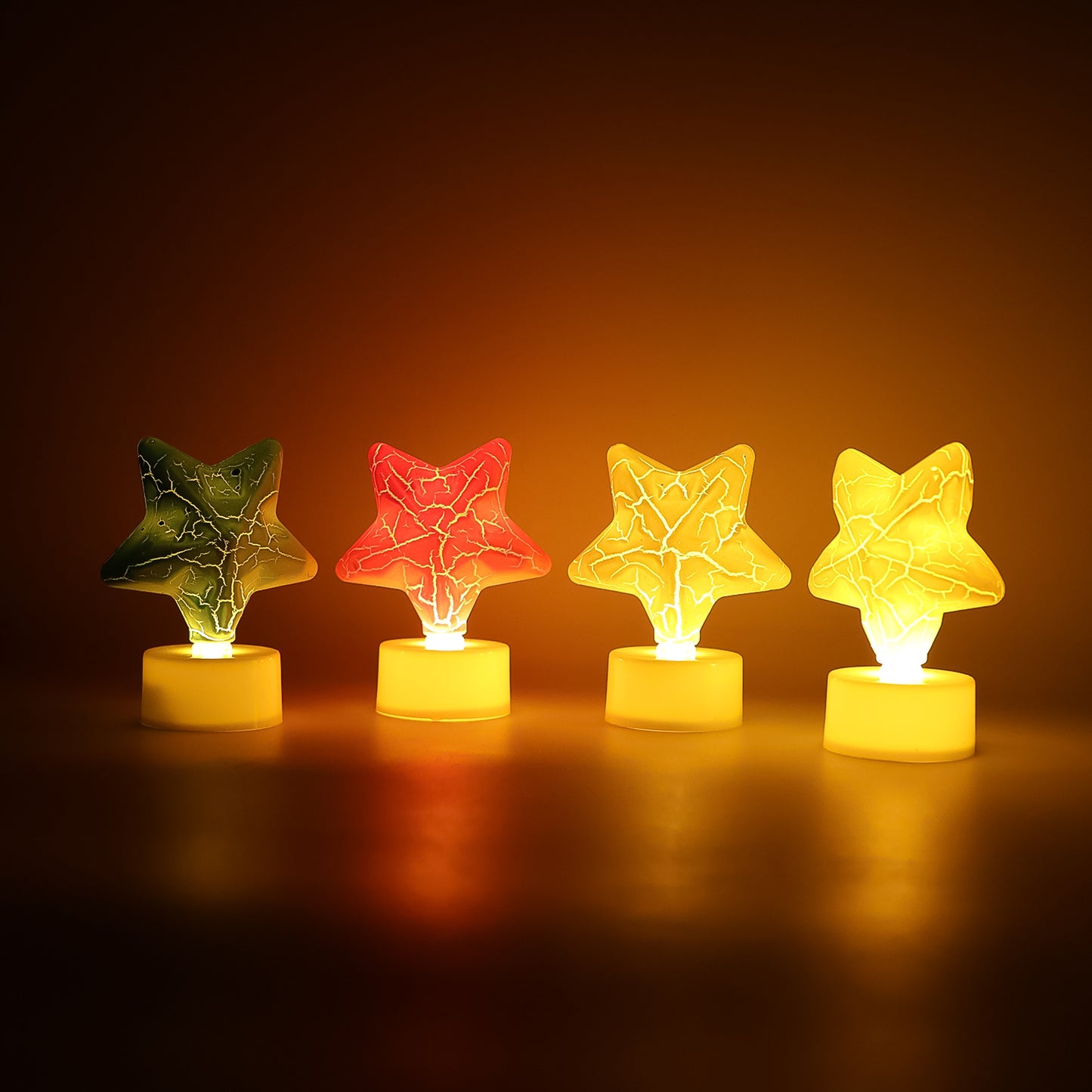 Set of four star-shaped decorative LED tealight candles by Wukusy for home decor, glowing softly in a cozy setting.
