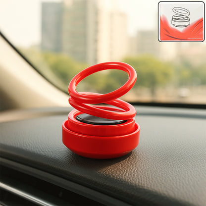 Small Wukusy solar car aroma air freshener hanging in a vehicle interior, compact automotive scent diffuser with solar panel.