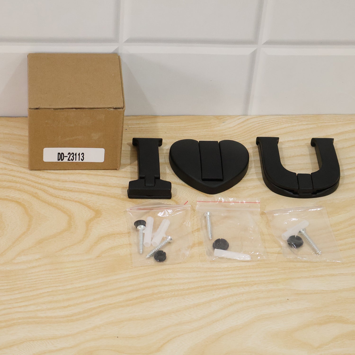 Wukusy premium heavy duty wall hook set with three 3-in-1 self-adhesive hooks for clothes and bags, mounted on a wall.