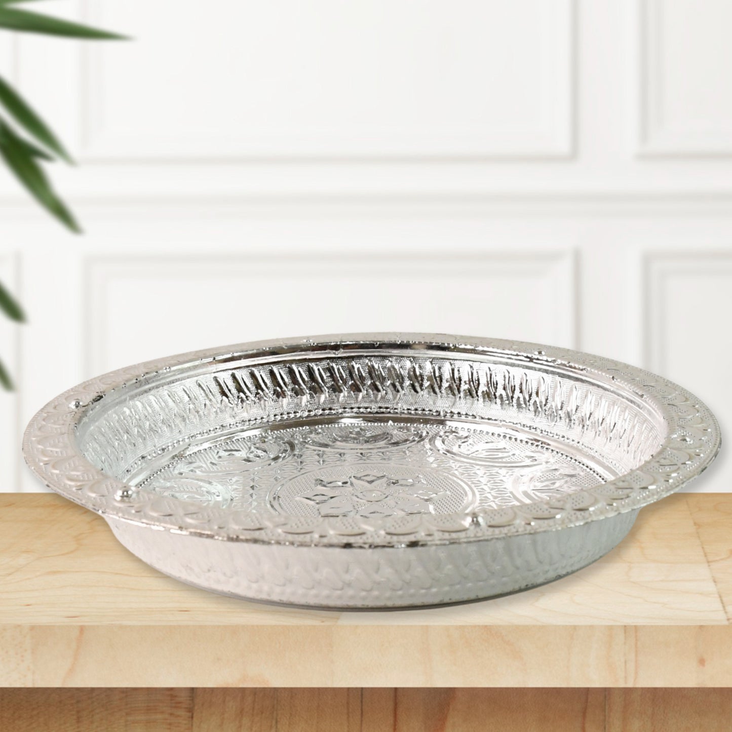 Silver finish plastic pooja thali for home worship, featuring traditional design suitable for religious ceremonies.