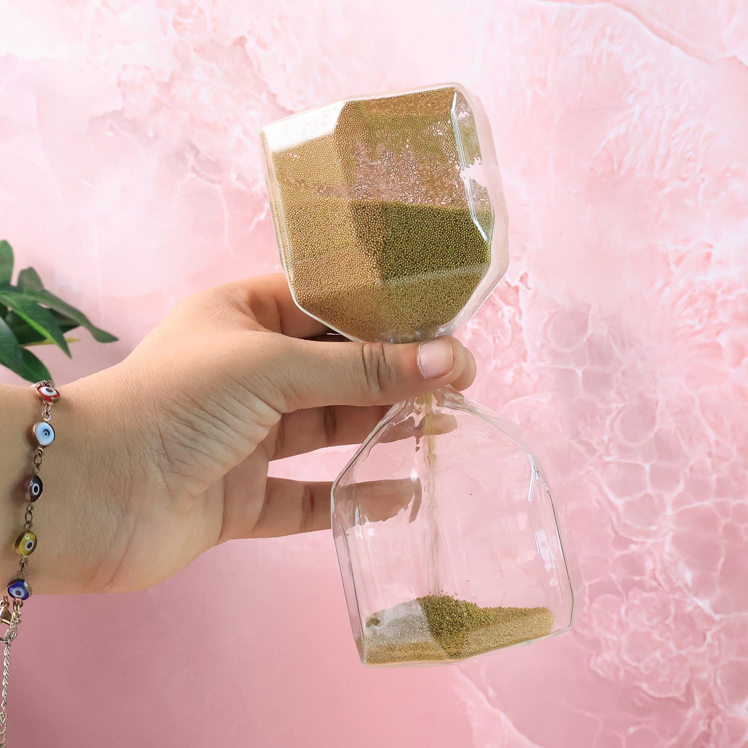 Faceted glass hourglass sand timer by Wukusy, 4-minute office timer with a decorative geometric design.