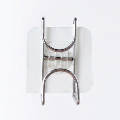 Transparent double loop adhesive wall hook by Wukusy, mounted on a wall with the hook loops visible for hanging items.