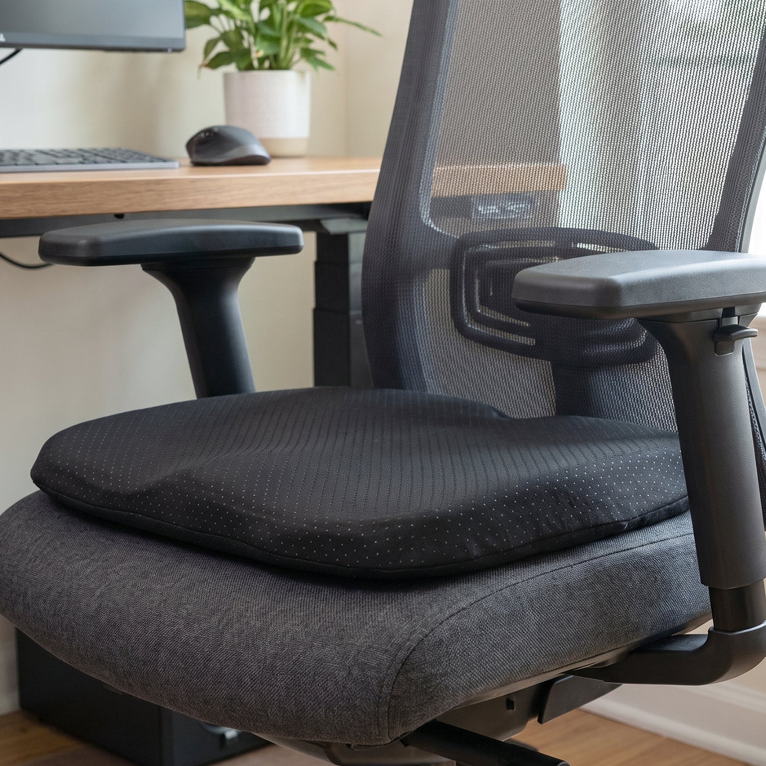 Wukusy ergonomic egg-shaped memory foam cushion for office and car seats, providing comfort and support during sitting.