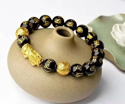 Ekom black and golden Lucky Bracelet with Pixiu charm, crafted for health and good fortune, featuring intricate design.