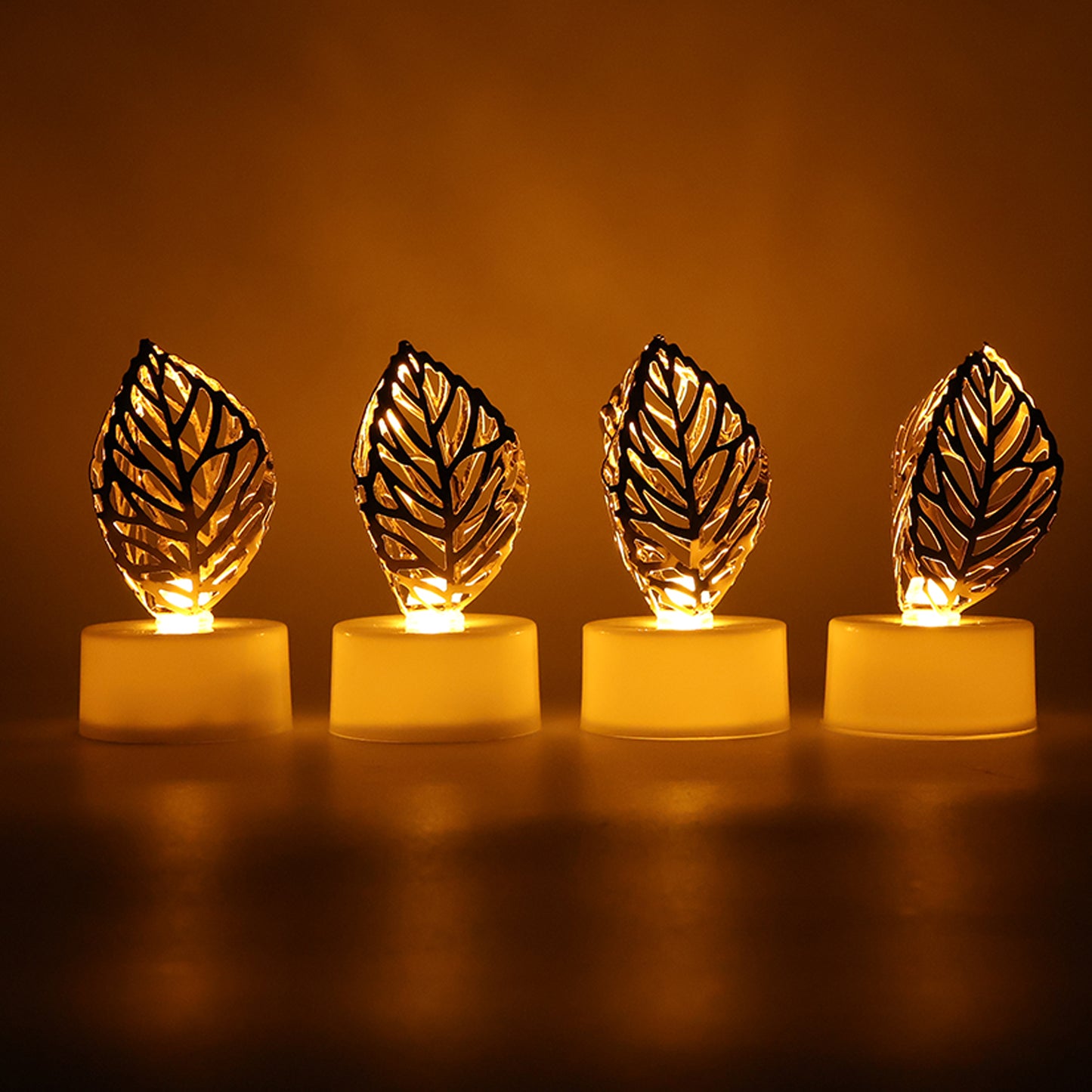 Set of four Wukusy decorative golden leaf-shaped flameless LED candles for elegant home decor.