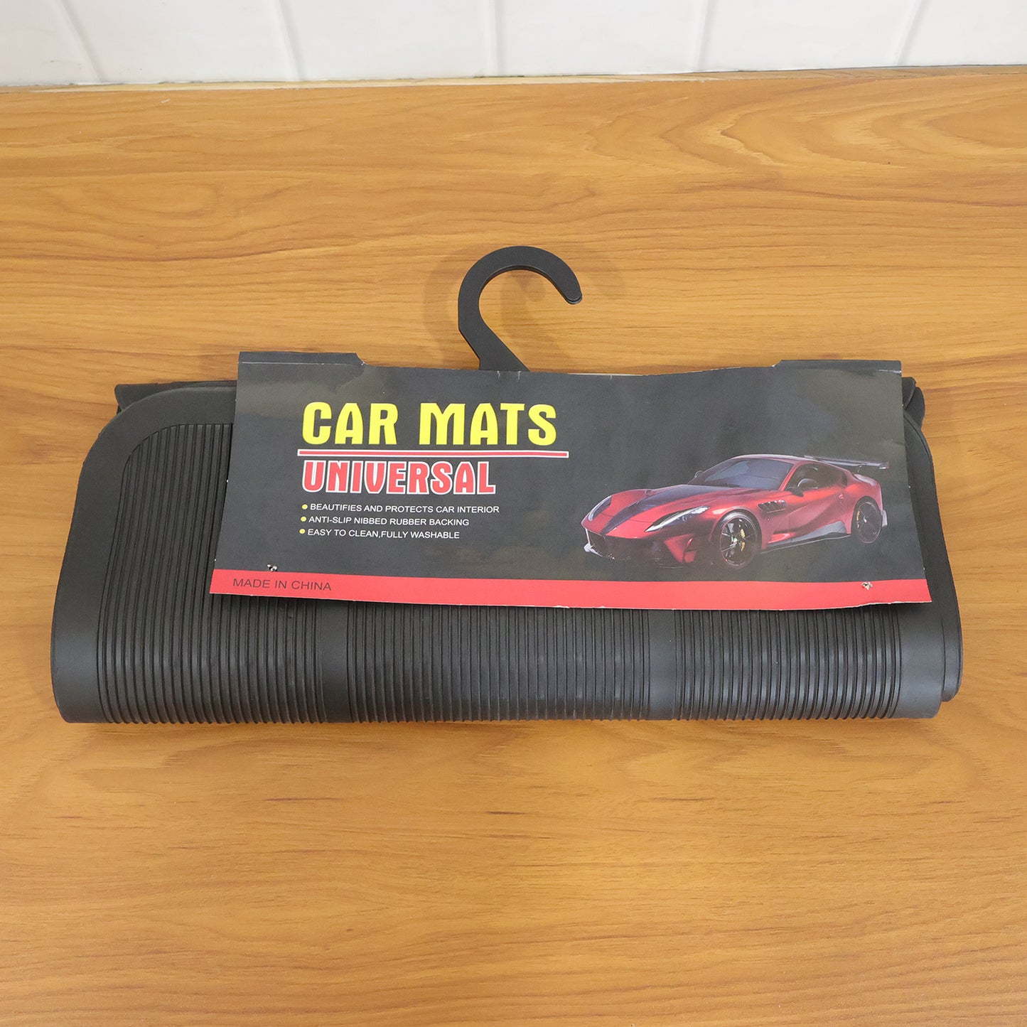 Set of four Wukusy universal car floor mats showing textured rubber surfaces and raised edges for all-weather protection.