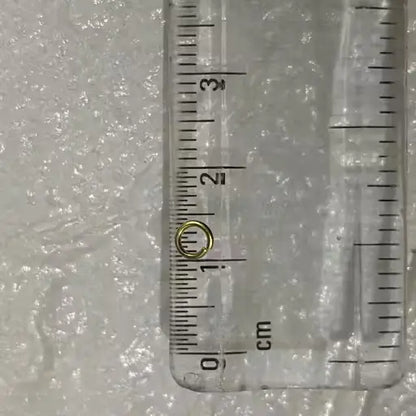 Set of 200 golden open jump rings for jewelry making supplies by Ekom, shown in a close-up image.