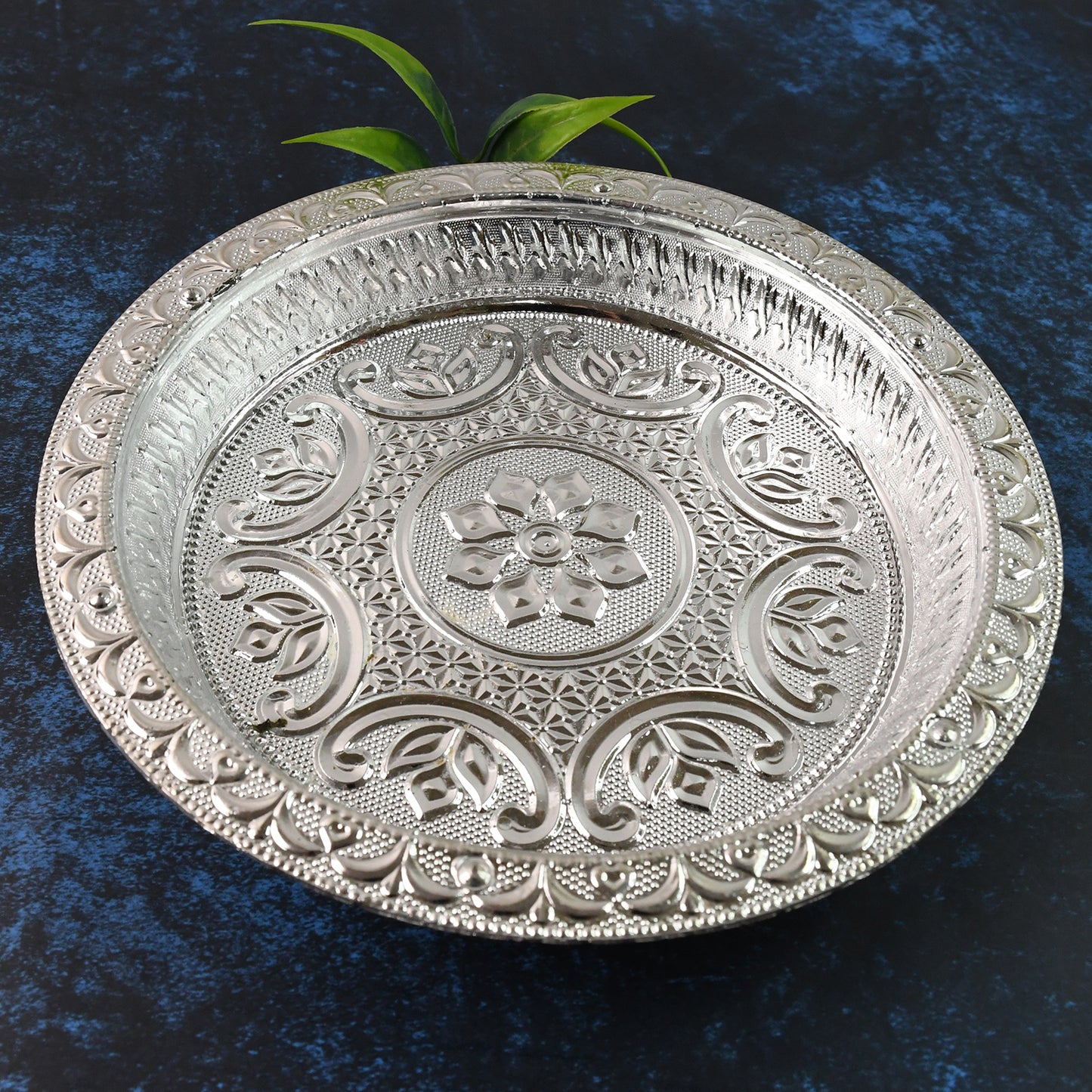 Traditional silver finish plastic pooja thali for home prayer rituals, featuring intricate design and spacious surface.