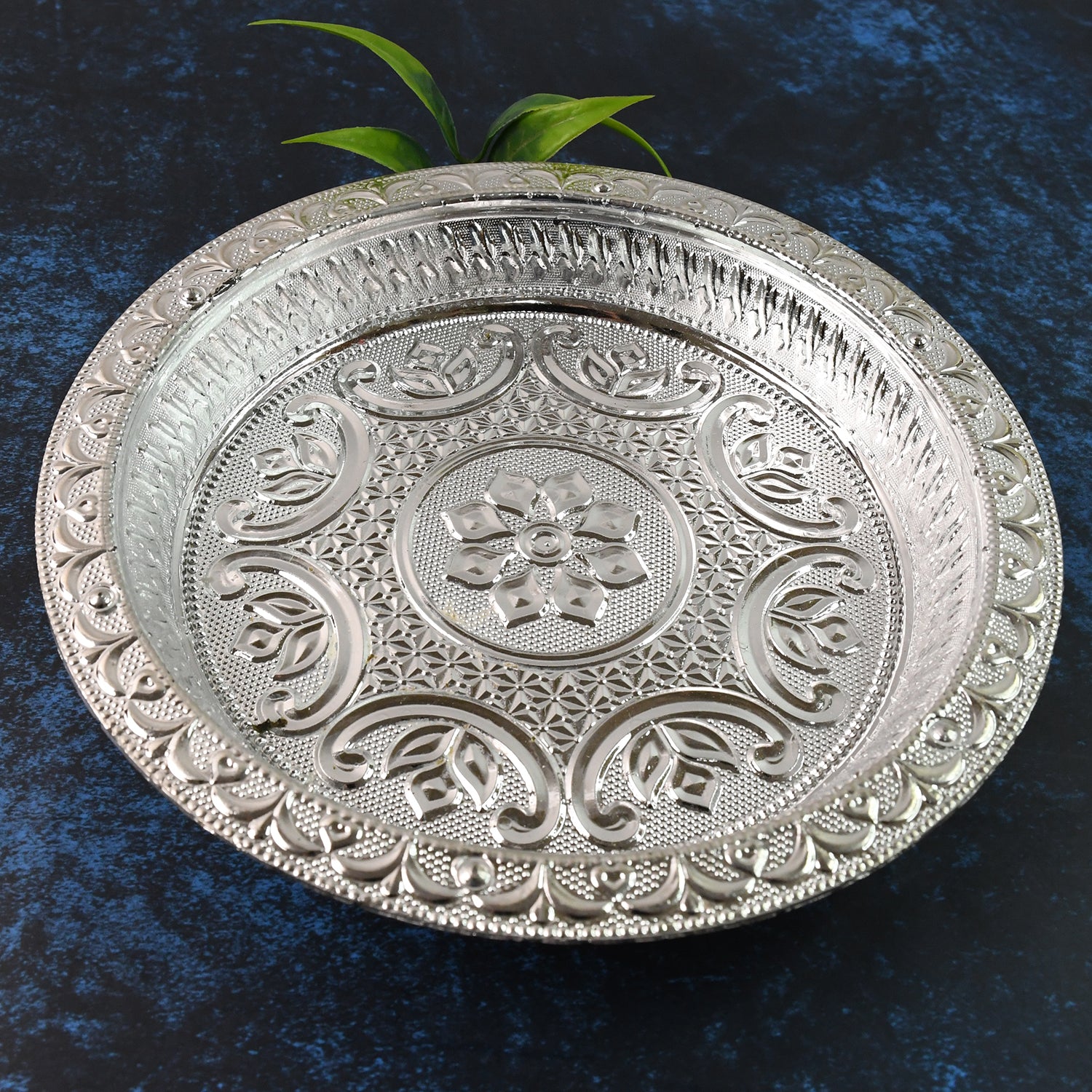 Traditional silver finish plastic pooja thali for home prayer rituals, featuring intricate design and spacious surface.