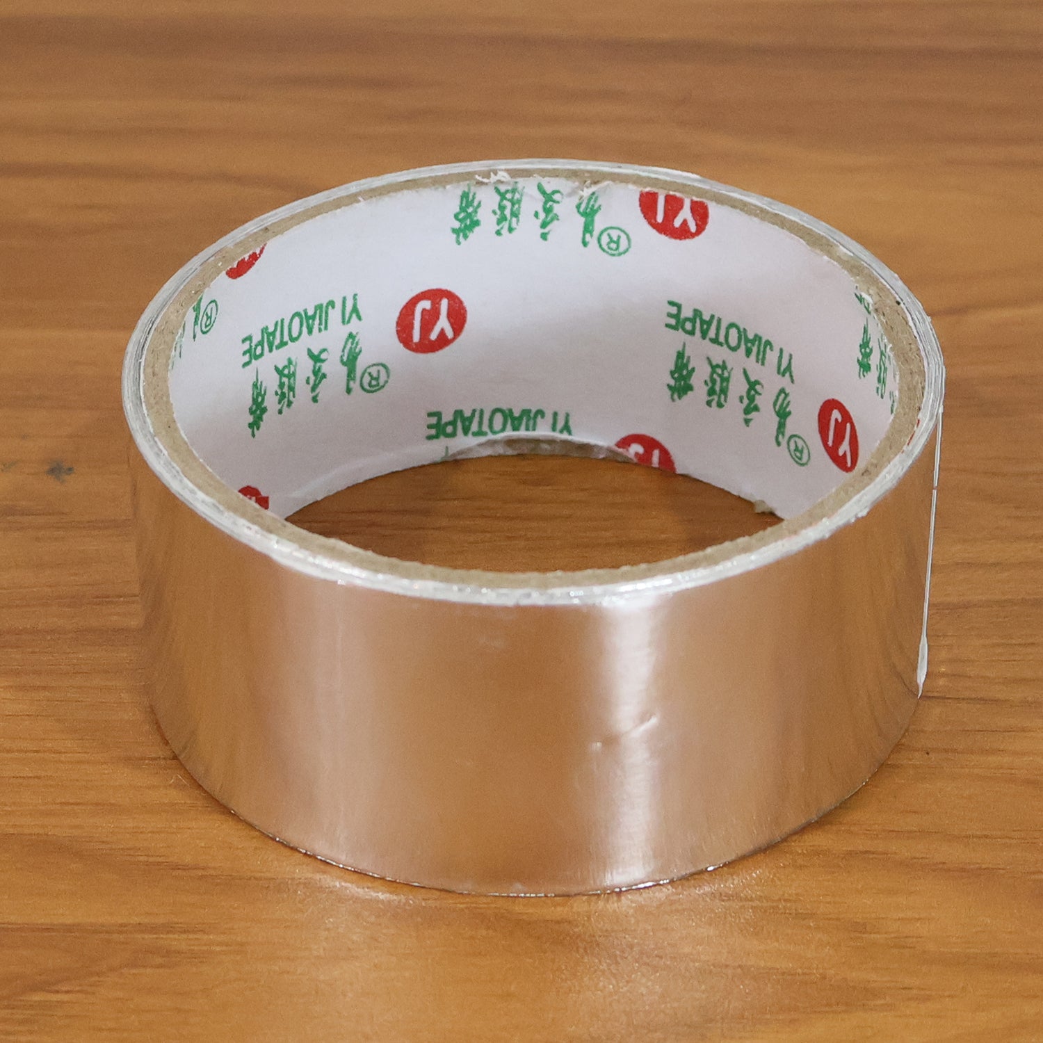 Wukusy heavy-duty aluminium foil adhesive tape, 8540 mm long, shown on a clean surface for sealing and insulation applications.